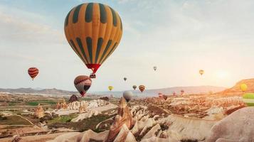 Amazing sunset over Cappadocia. Beautiful color balloons. Turkey photo