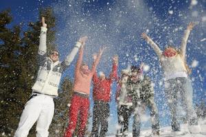 friends have fun at winter on fresh snow photo